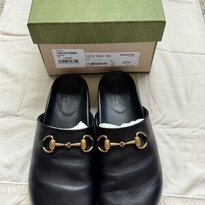 Gucci Black Leather Slip-Ons with Gold Accents
